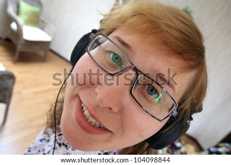 Joyful woman wearing headphones, listening to music in the room /Crazy music, bizarre people!!!