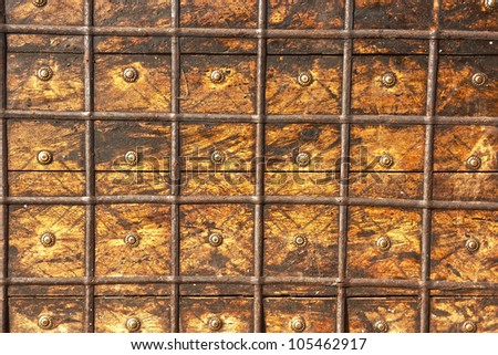 Photografy of old chest aged with decorative nails and rusty metal may be used as background.