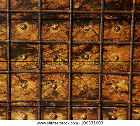 Photo of old chest aged with decorative nails and rusty metal may be used as background.