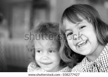 Laughing girl 6 years and her sister/This is real joy!