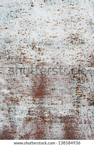 Rusty old metal plate with white paint.