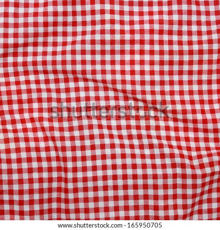 Abstract background texture of a red and white checkered picnic blanket Red linen crumpled tablecloth