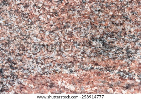 Old red granite background with scratches. Natural granite texture.