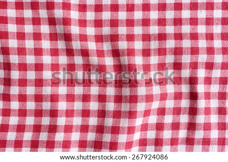 Red and white fabric texture. Red linen checkered tablecloth background.