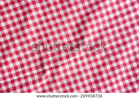 Red linen picnic tablecloth background. Red and white fabric texture.