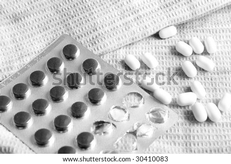 black and white tablets on the towel