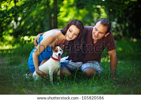 Young couple with dog on picnic in park