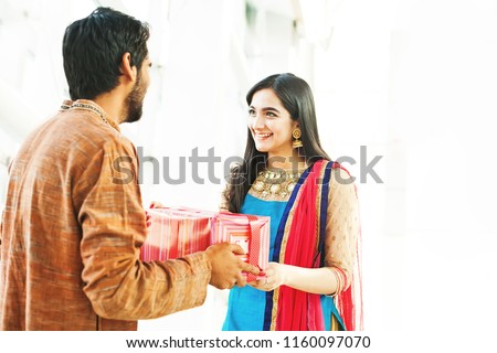Raksha bandhan (rakhi, rakshabandhan) concept. Indian brother giving gift to his sister