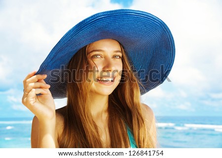 Happy blonde woman against sea water