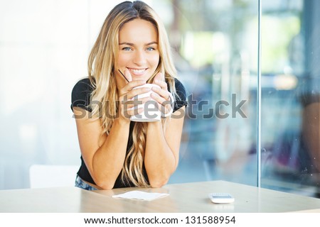 Woman Drinking Coffee In The Morning At Restaurant (Soft Focus On Eyes)