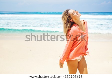 woman on the beach in pink shirt woman on the beach in pink shirt