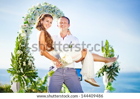cheerful bride and groom on the wedding venue outdoors