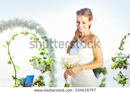 bride in a flourish arch on the wedding venue, bali