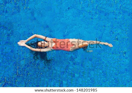 beautiful woman in the swimming pool - top view