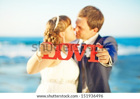 couple holding love letters on wedding day - soft focus on letters