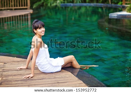 woman in jungle spa near swimming pool
