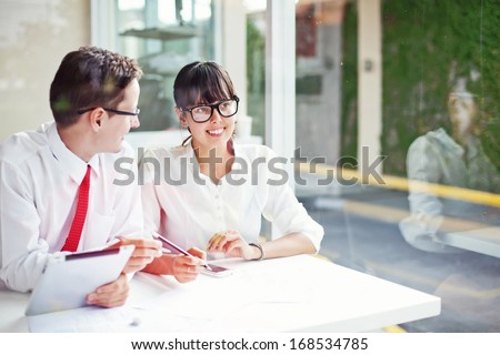 two office workers creating together (focus on face of woman)