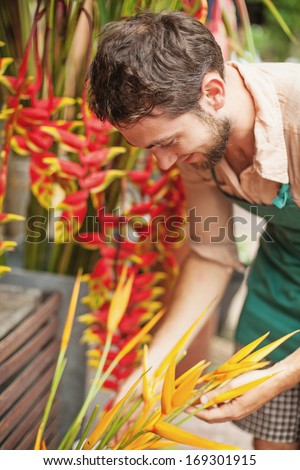 handsome florist in his flower shop (focus on his eyes)