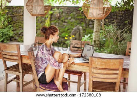 beautiful woman sitting near computer at home