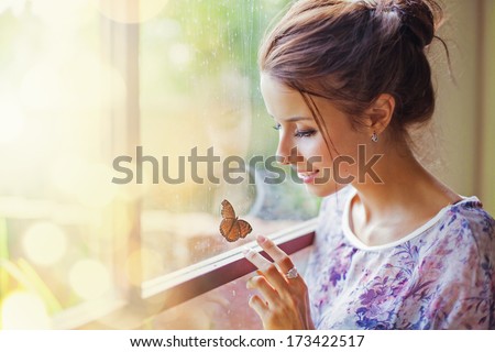 woman touching a butterfly