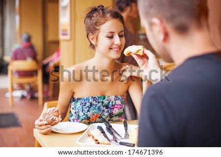 Couple Feeding Each Other With The Cake In Restaurant