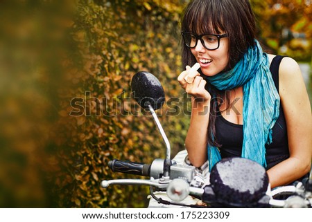 Stylish woman riding a motorbike