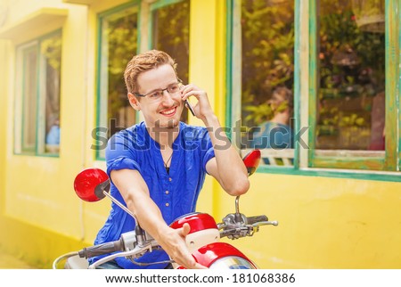 Man talking on phone on his motorbike