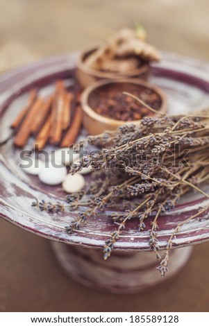 Soft focus on spa ingredients with dry herbs such as lavender and spices