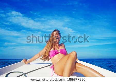 Woman relaxing on a boat and laughing