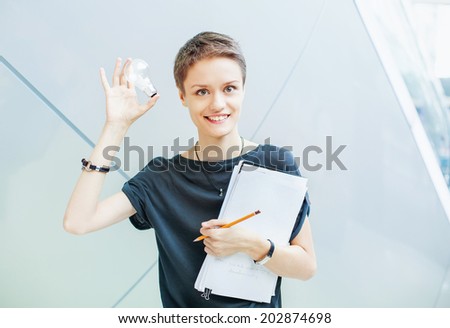 Creative idea concept. Woman holding a lamp