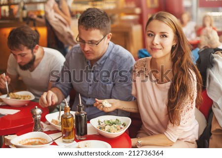 friends eating together focus on a woman friends eating together focus on a woman