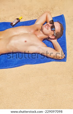 tanning man on a beach