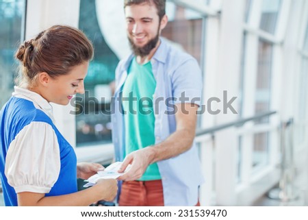 Beautiful flight attendant checking documents in airport