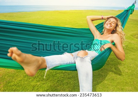 carefree woman relaxing in a hammock