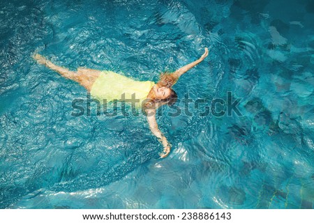 woman swimming in the pool - top view