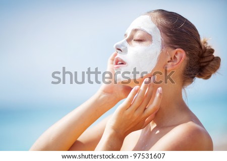 woman on the beach with mask on face