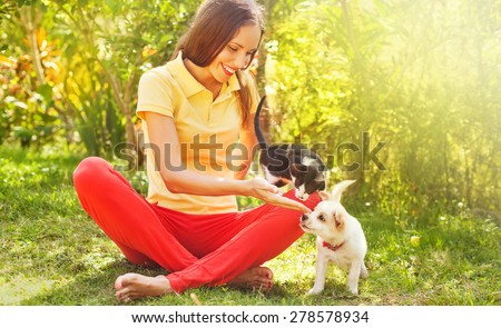 woman playing with her can and dog outdoors