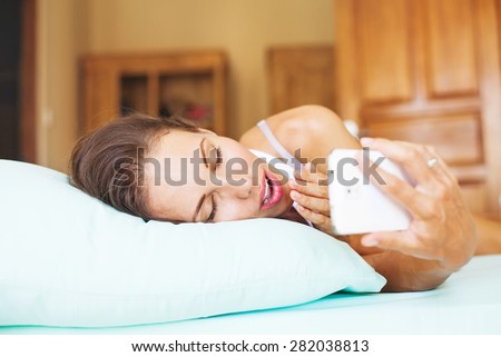 Woman using her phone as alarm clock