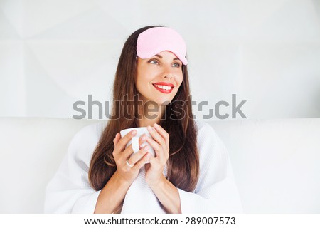 woman drinking hot beverage before going to bed to help her sleep