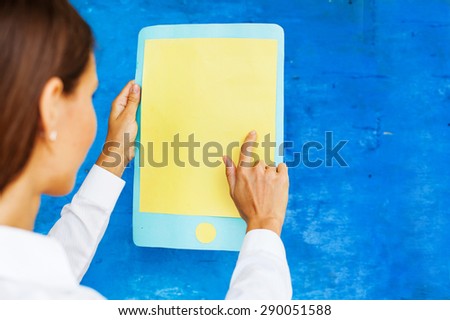 woman using a big paper smart phone