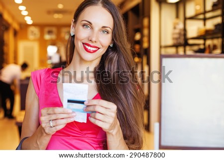satisfied customer after purchase, Woman holding card and bill. Blank advertising space on a background