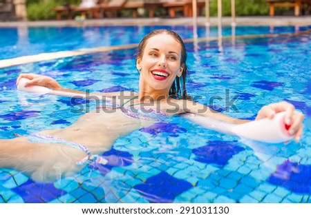 woman doing water aerobics with a noodle
