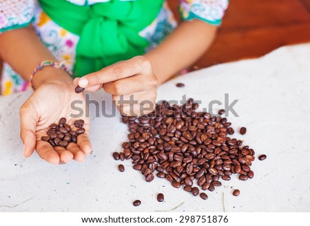 Closeup photo of woman choosing the coffee beans of the best quality