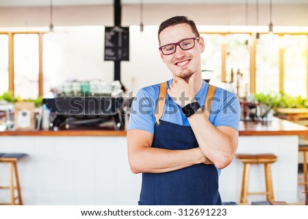 handsome restaurant owner standing in front of the coffee bar