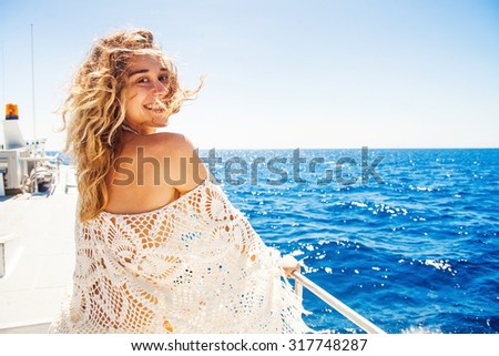 woman relaxing on a cruise boat on windy sunny day