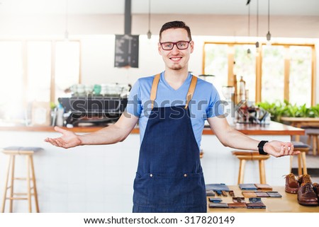 handsome shop owner inviting to his shop