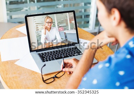 video call. woman and man talking on web camera in office