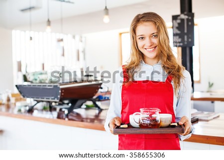 woman working as waitress holding a tray with tea and coffee