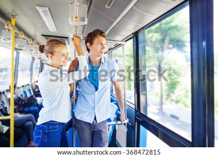 man and woman traveling by bus