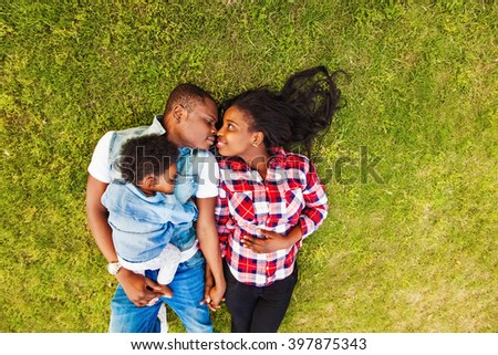 african american family on a perfect green lawn